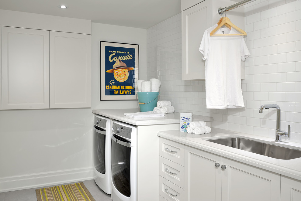 Large elegant galley ceramic tile dedicated laundry room photo in Toronto with an undermount sink, recessed-panel cabinets, white cabinets, quartz countertops, white walls, a side-by-side washer/dryer and white countertops