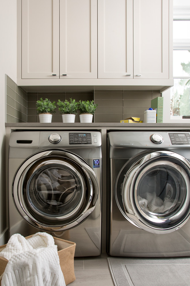 This is an example of a medium sized traditional separated utility room in Calgary with shaker cabinets, white cabinets, engineered stone countertops, white walls, porcelain flooring and a side by side washer and dryer.