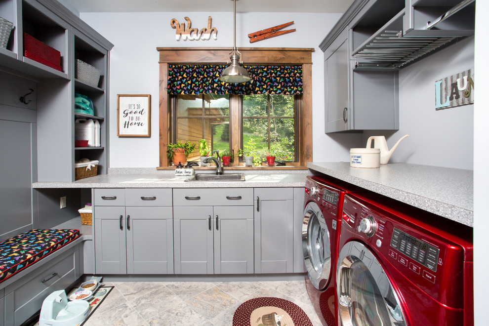 Laundry room - mid-sized rustic u-shaped porcelain tile and gray floor laundry room idea in Other with a drop-in sink, shaker cabinets, gray cabinets, gray walls and a side-by-side washer/dryer