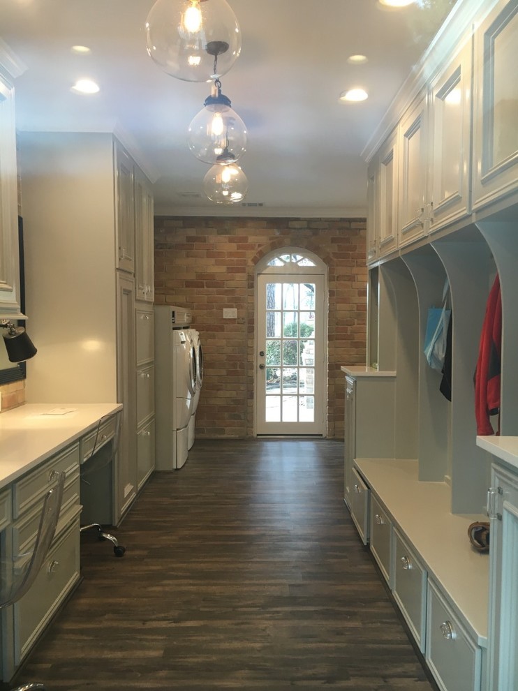 Transitional dark wood floor utility room photo in Houston with a side-by-side washer/dryer and white walls