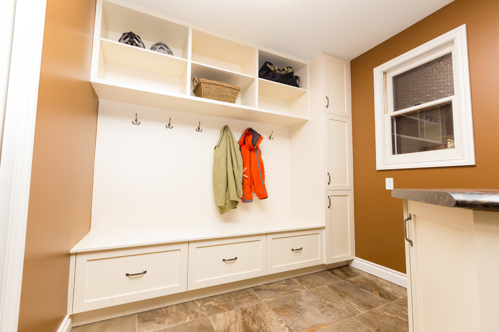Inspiration for a medium sized traditional galley utility room in Toronto with shaker cabinets, white cabinets, brown walls, porcelain flooring, a side by side washer and dryer and grey floors.