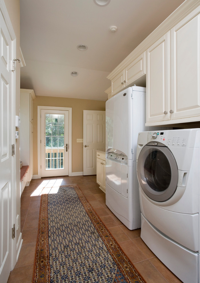 Inspiration for a large classic galley separated utility room in Chicago with raised-panel cabinets, white cabinets, granite worktops, beige walls, ceramic flooring and a side by side washer and dryer.