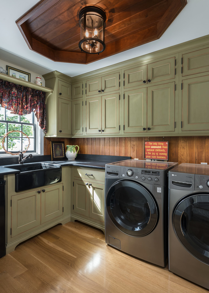 Laundry room - country laundry room idea in St Louis with a farmhouse sink, green cabinets and a side-by-side washer/dryer