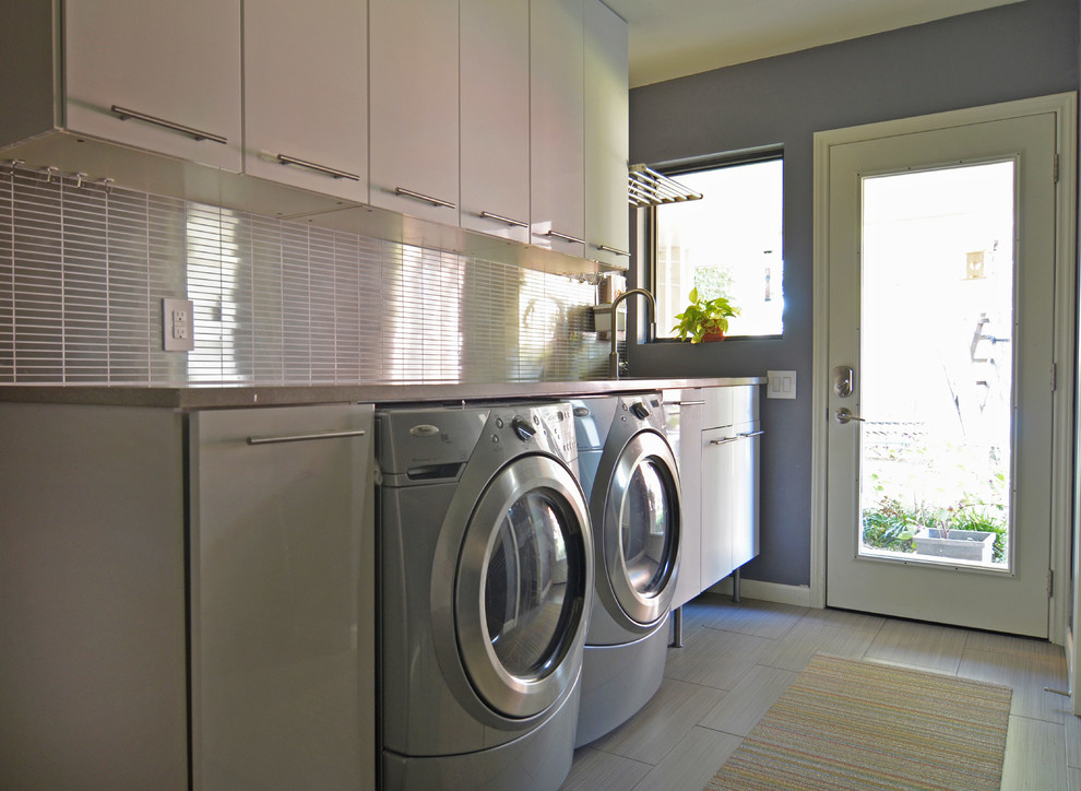 Example of a mid-century modern laundry room design in Dallas