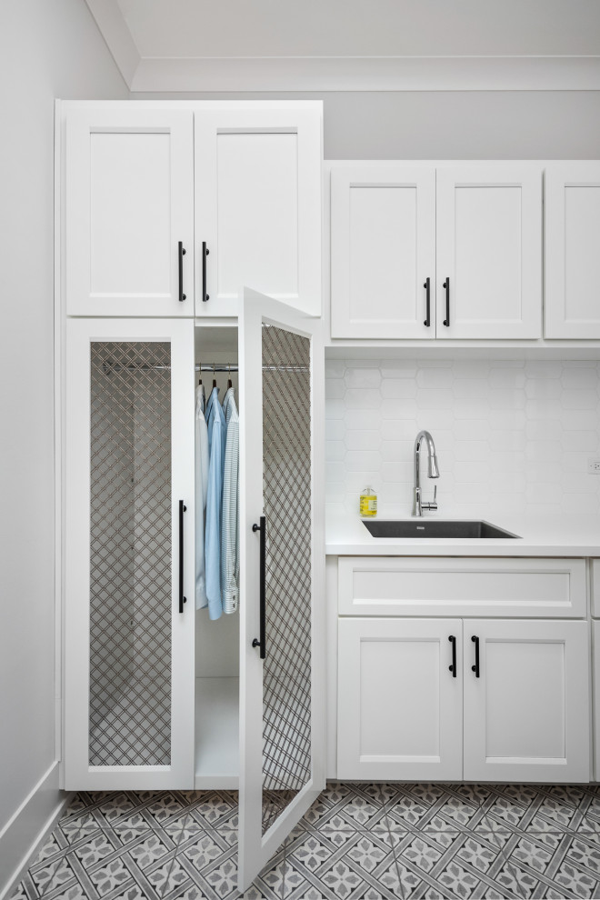 Country utility room in Chicago with a single-bowl sink, shaker cabinets, white cabinets, white splashback, grey walls, multi-coloured floors and white worktops.