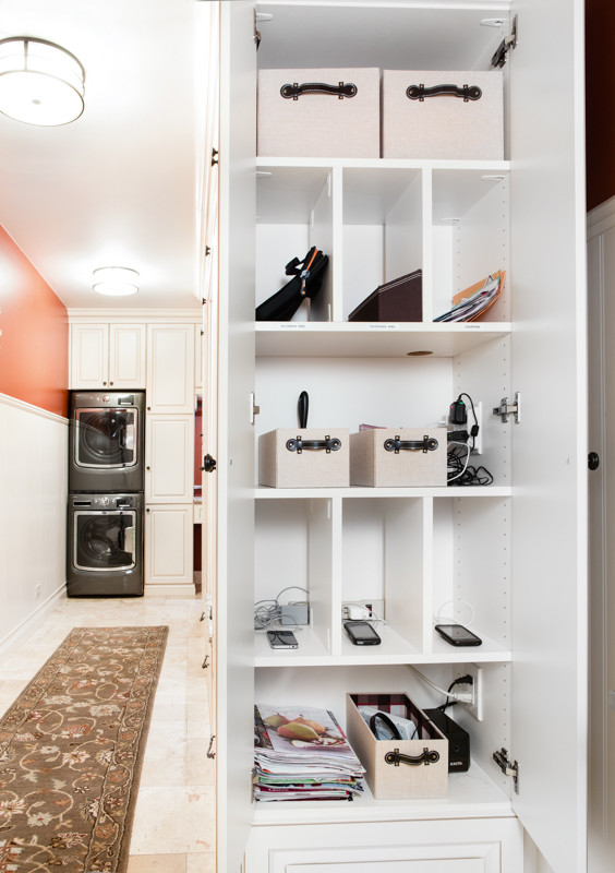 シカゴにある小さなトラディショナルスタイルのおしゃれな家事室 (白いキャビネット、ラミネートカウンター、オレンジの壁、セラミックタイルの床、上下配置の洗濯機・乾燥機、レイズドパネル扉のキャビネット) の写真