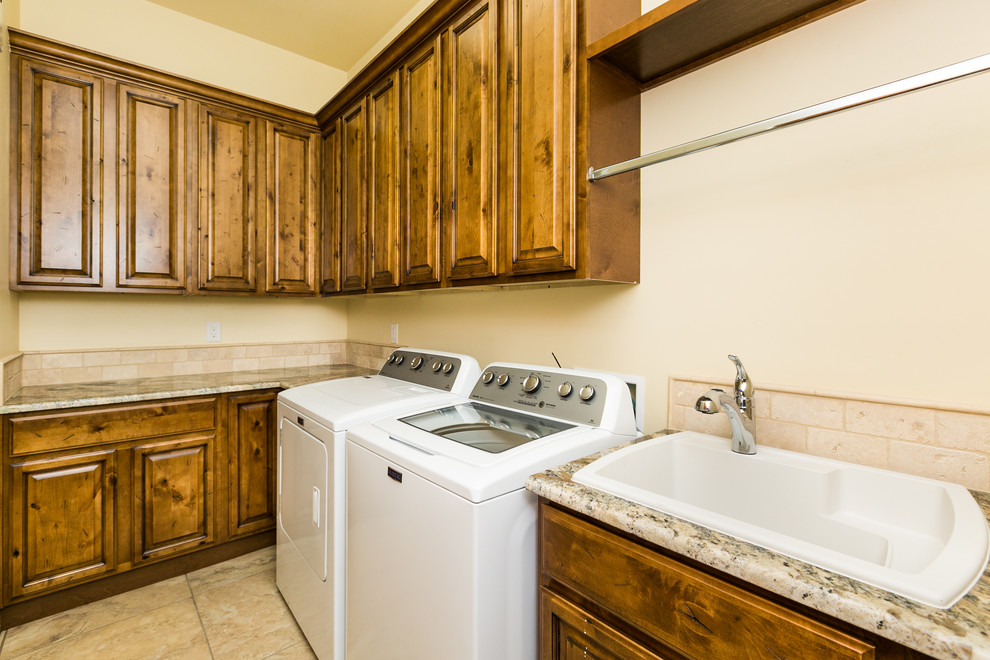 Example of a mid-sized mountain style l-shaped ceramic tile dedicated laundry room design in Albuquerque with granite countertops, beige walls and a side-by-side washer/dryer