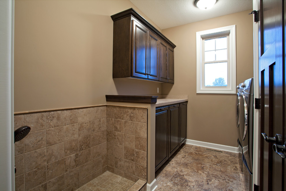 Mid-sized elegant galley porcelain tile and brown floor utility room photo in Minneapolis with raised-panel cabinets, medium tone wood cabinets, laminate countertops, beige walls, a side-by-side washer/dryer and beige countertops