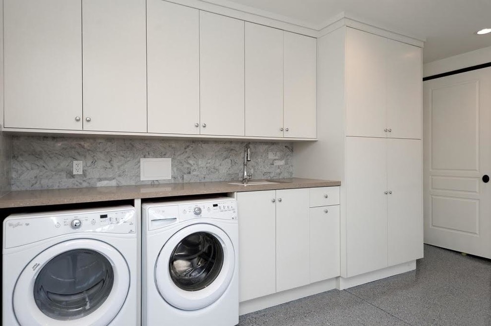Large classic single-wall separated utility room in Los Angeles with a built-in sink, flat-panel cabinets, white cabinets, laminate countertops, white walls, ceramic flooring, a side by side washer and dryer and grey floors.