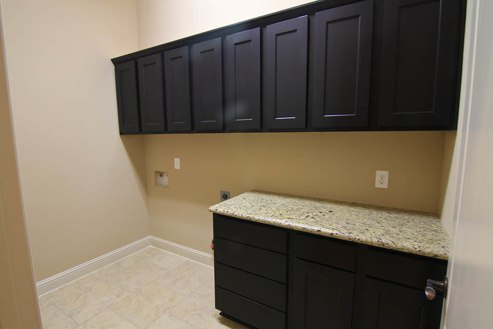 Inspiration for a medium sized traditional single-wall utility room in Houston with shaker cabinets, dark wood cabinets, granite worktops, beige walls, ceramic flooring, a side by side washer and dryer and beige floors.