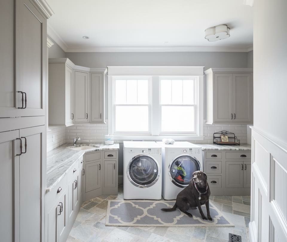 Mid-sized elegant galley limestone floor and gray floor utility room photo in Cincinnati with shaker cabinets, white cabinets, granite countertops, gray walls, an undermount sink and a side-by-side washer/dryer