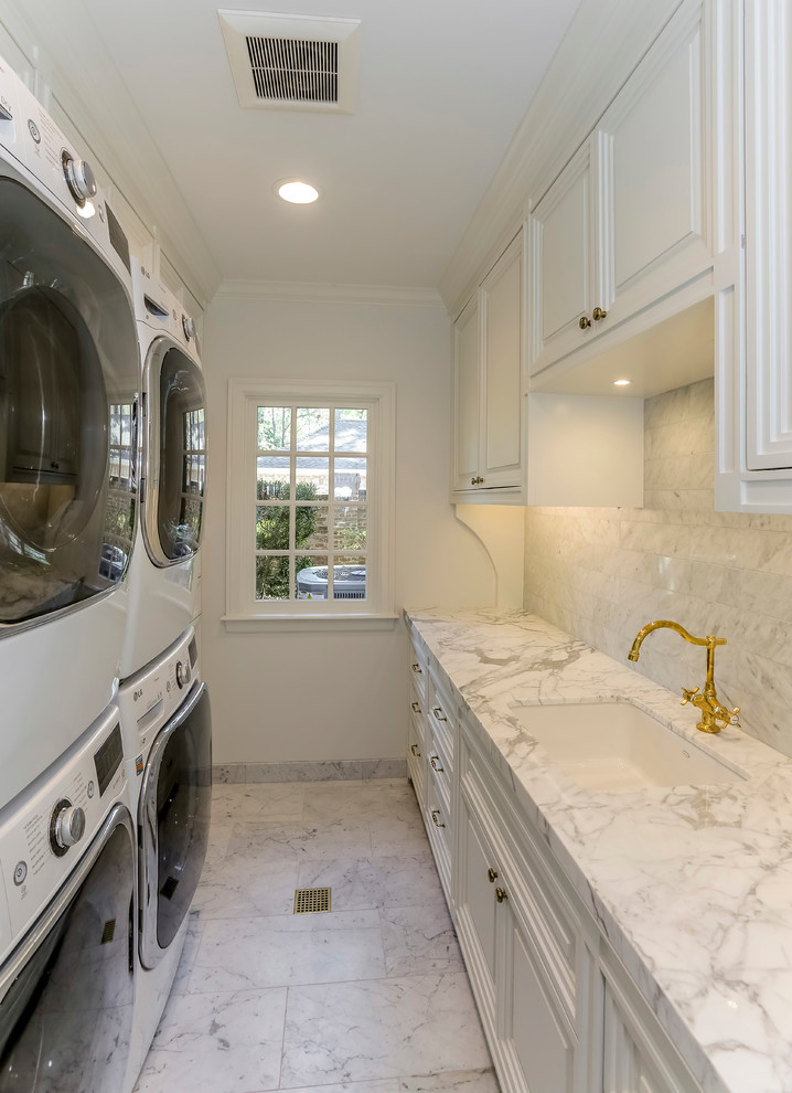 Idéer för en mellanstor klassisk parallell tvättstuga enbart för tvätt, med en undermonterad diskho, luckor med upphöjd panel, vita skåp, marmorbänkskiva, vita väggar, marmorgolv och en tvättpelare