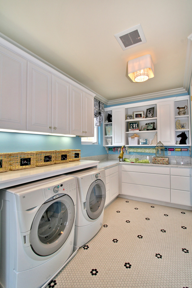 Inspiration for a contemporary white floor laundry room remodel in San Diego with white cabinets