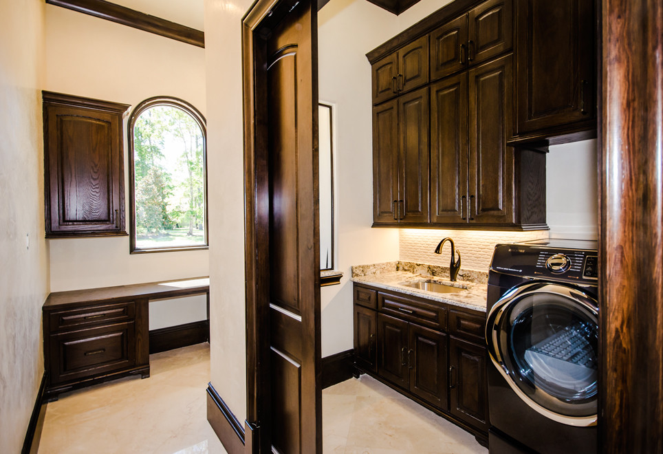 Mediterranean galley utility room in Houston with flat-panel cabinets, dark wood cabinets, granite worktops, beige walls, porcelain flooring and a side by side washer and dryer.