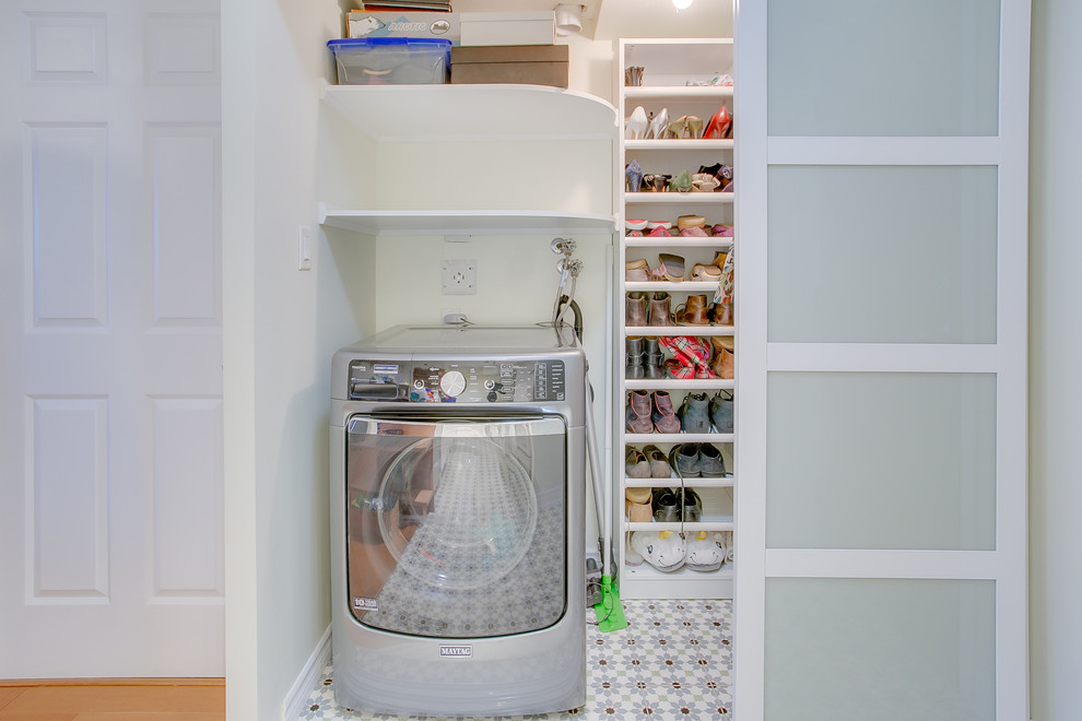 Laundry closet - small contemporary single-wall concrete floor and multicolored floor laundry closet idea in Toronto with open cabinets, white cabinets, white walls and a concealed washer/dryer