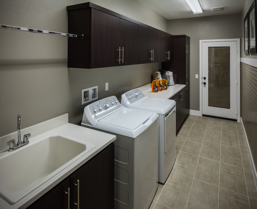 Inspiration for a traditional utility room in Los Angeles with an utility sink, flat-panel cabinets, engineered stone countertops, ceramic flooring and a side by side washer and dryer.
