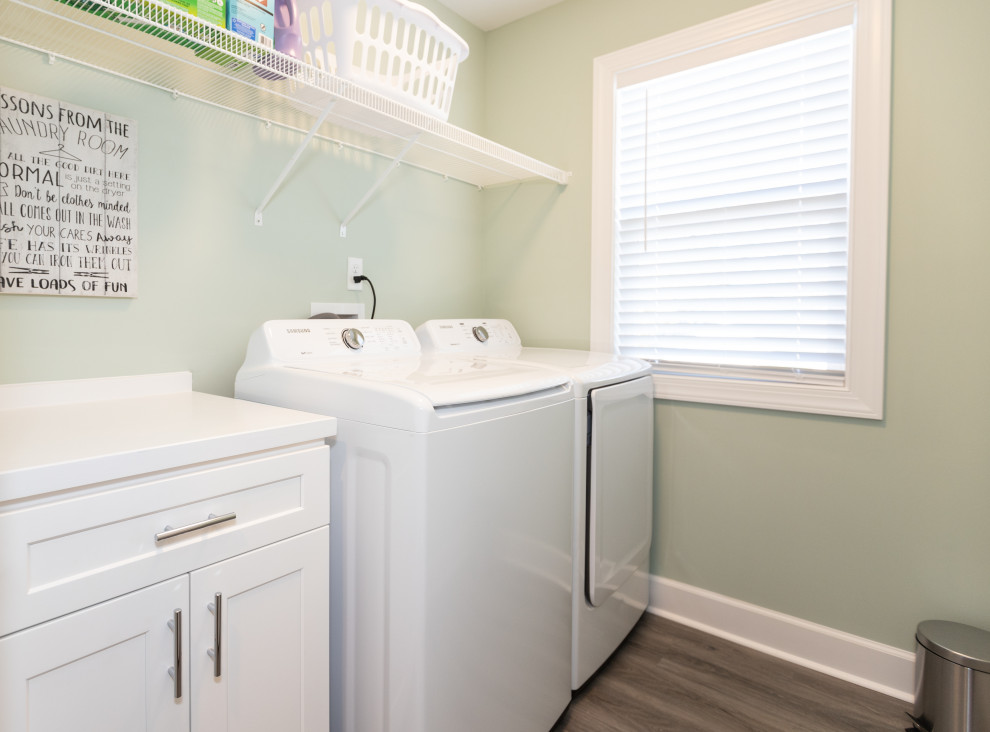 Inspiration for a mid-sized coastal galley laminate floor and gray floor dedicated laundry room remodel in Other with shaker cabinets, white cabinets, wood countertops, blue walls, a side-by-side washer/dryer and white countertops