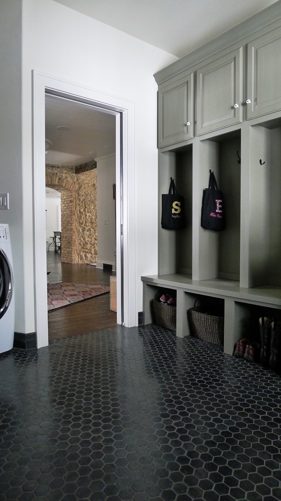 Cottage black floor laundry room photo in Other