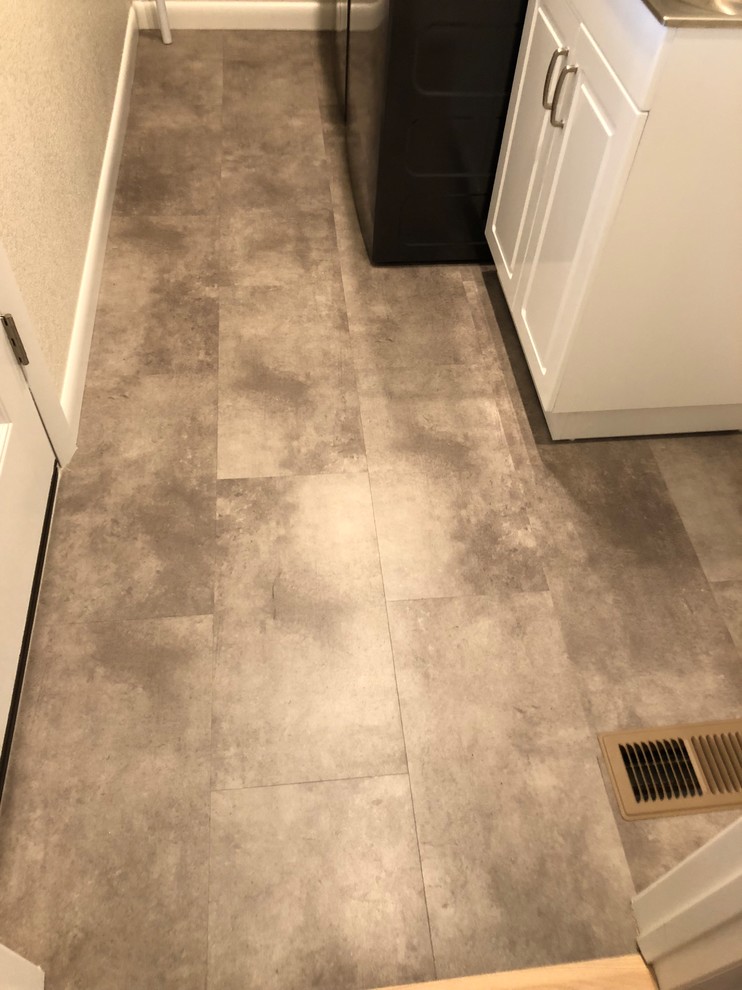 Example of a small trendy vinyl floor dedicated laundry room design in Denver with an utility sink and a side-by-side washer/dryer