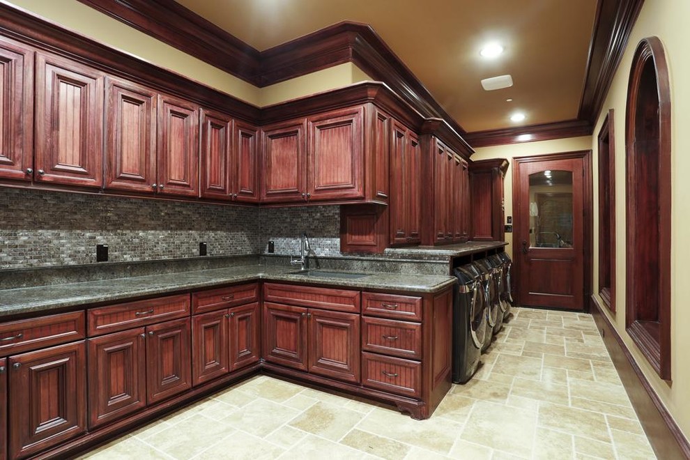 Design ideas for a large traditional single-wall separated utility room in Houston with a built-in sink, raised-panel cabinets, granite worktops, beige walls, terracotta flooring, a side by side washer and dryer and dark wood cabinets.