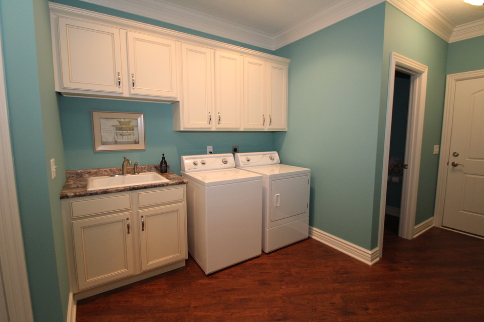 Nautical utility room in Other with an utility sink, recessed-panel cabinets, white cabinets, blue walls, medium hardwood flooring and a side by side washer and dryer.