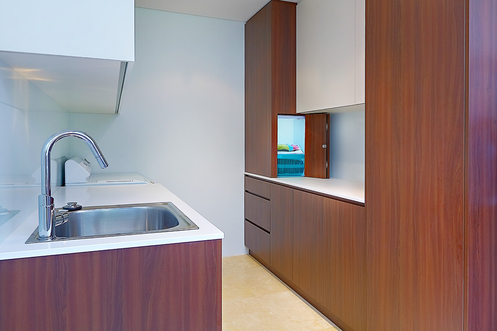 This is an example of a contemporary utility room in Sydney with a built-in sink.