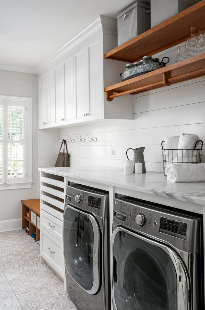 Utility room - mid-sized traditional single-wall ceramic tile and gray floor utility room idea in Atlanta with a single-bowl sink, shaker cabinets, white cabinets, marble countertops, gray walls, a side-by-side washer/dryer and white countertops