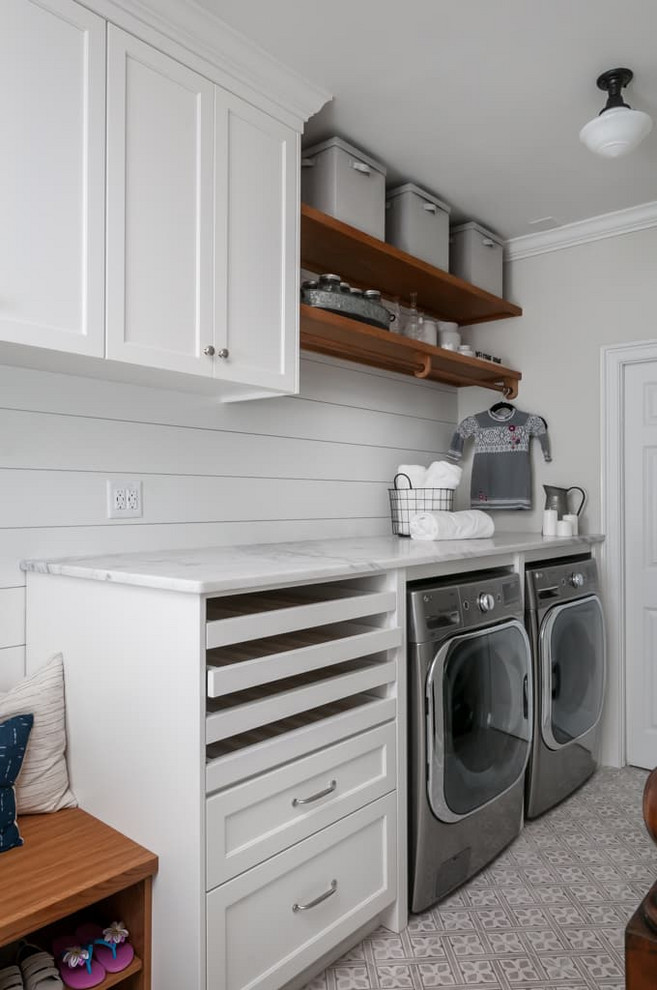 Inspiration for a mid-sized timeless single-wall ceramic tile and gray floor utility room remodel in Atlanta with a single-bowl sink, shaker cabinets, white cabinets, marble countertops, gray walls, a side-by-side washer/dryer and white countertops