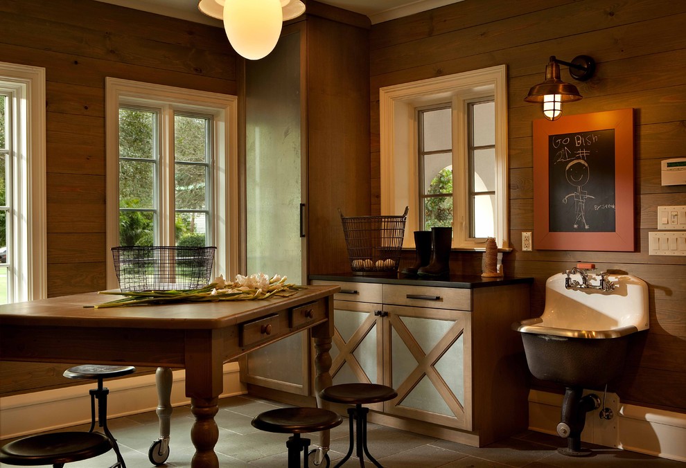 This is an example of a large traditional utility room in Orlando with an utility sink, engineered stone countertops, brown walls, slate flooring, brown floors and medium wood cabinets.