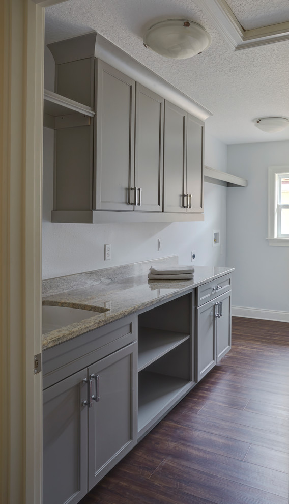 Inspiration for a medium sized modern galley separated utility room in Orlando with a submerged sink, shaker cabinets, grey cabinets, engineered stone countertops, grey walls, dark hardwood flooring and a side by side washer and dryer.