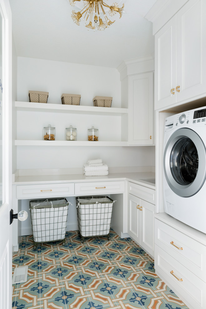 Inspiration for a large transitional l-shaped terra-cotta tile and blue floor dedicated laundry room remodel in Minneapolis with an undermount sink, white cabinets, solid surface countertops, white walls, a side-by-side washer/dryer and white countertops