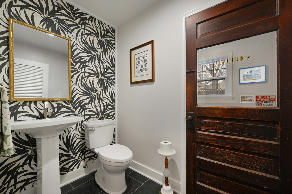 This is an example of a medium sized traditional utility room in Kansas City with white walls and a side by side washer and dryer.