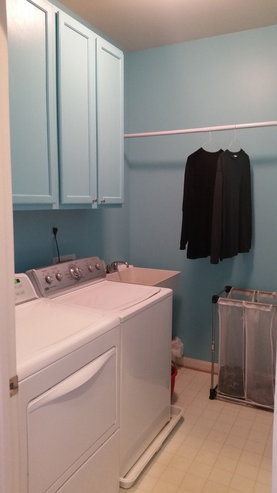Inspiration for a medium sized traditional single-wall separated utility room in DC Metro with an utility sink, recessed-panel cabinets, blue cabinets, blue walls, vinyl flooring and beige floors.