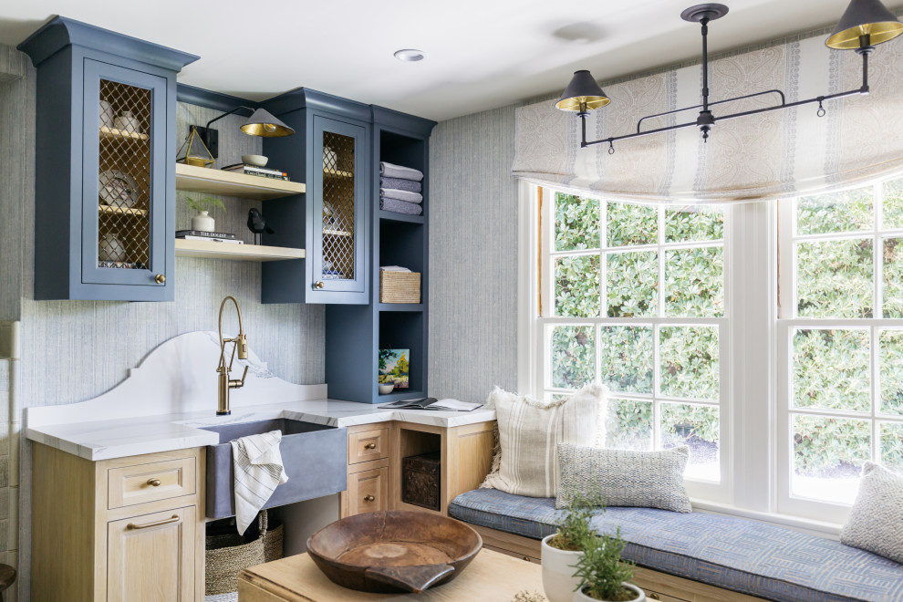 Inspiration for a medium sized contemporary galley utility room in Los Angeles with a submerged sink, shaker cabinets, blue cabinets, marble worktops, blue walls, a side by side washer and dryer and white worktops.