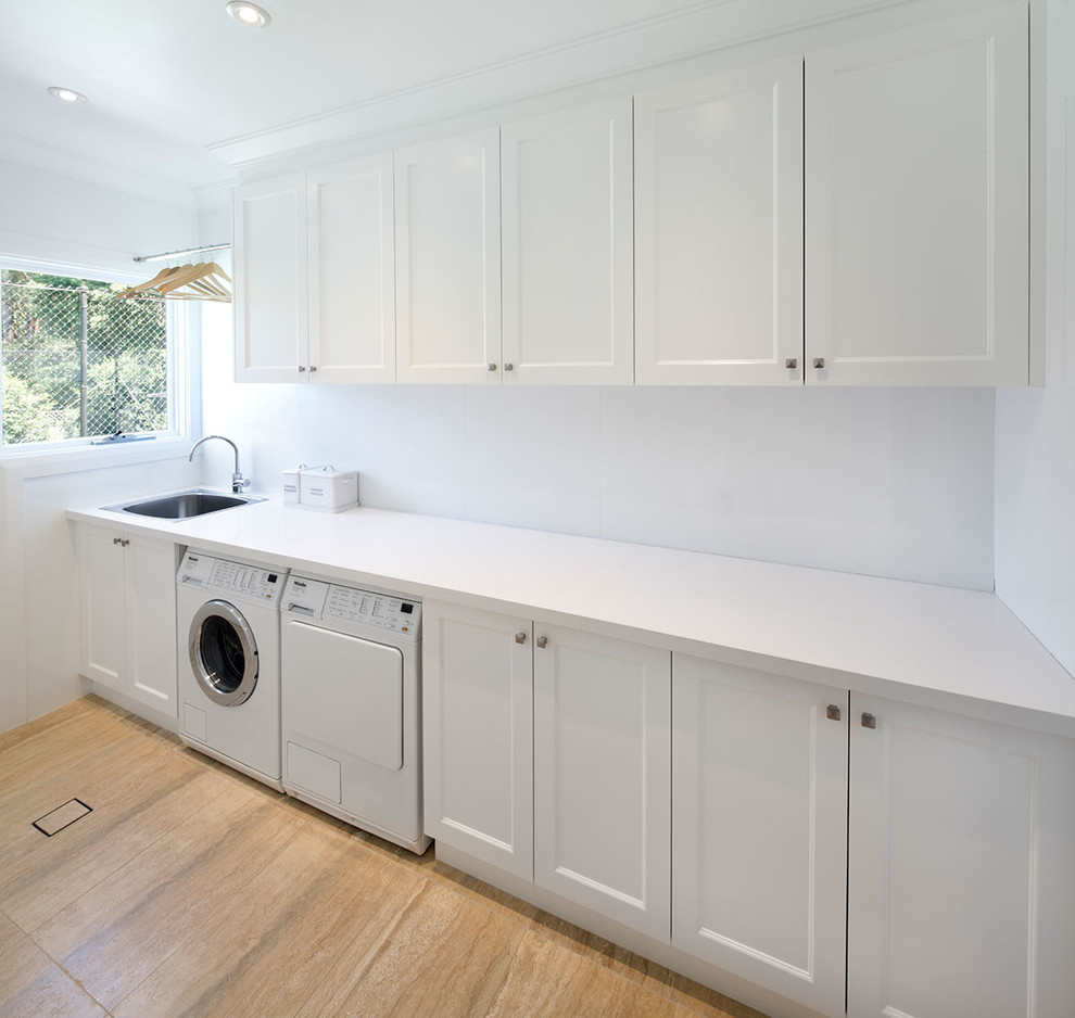Large elegant galley light wood floor dedicated laundry room photo in Sydney with a single-bowl sink, shaker cabinets, white cabinets, quartz countertops, white walls and a side-by-side washer/dryer