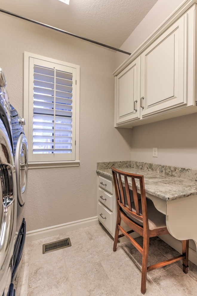 Medium sized traditional single-wall separated utility room in Oklahoma City with raised-panel cabinets, white cabinets, granite worktops, beige walls, ceramic flooring, a side by side washer and dryer and beige floors.