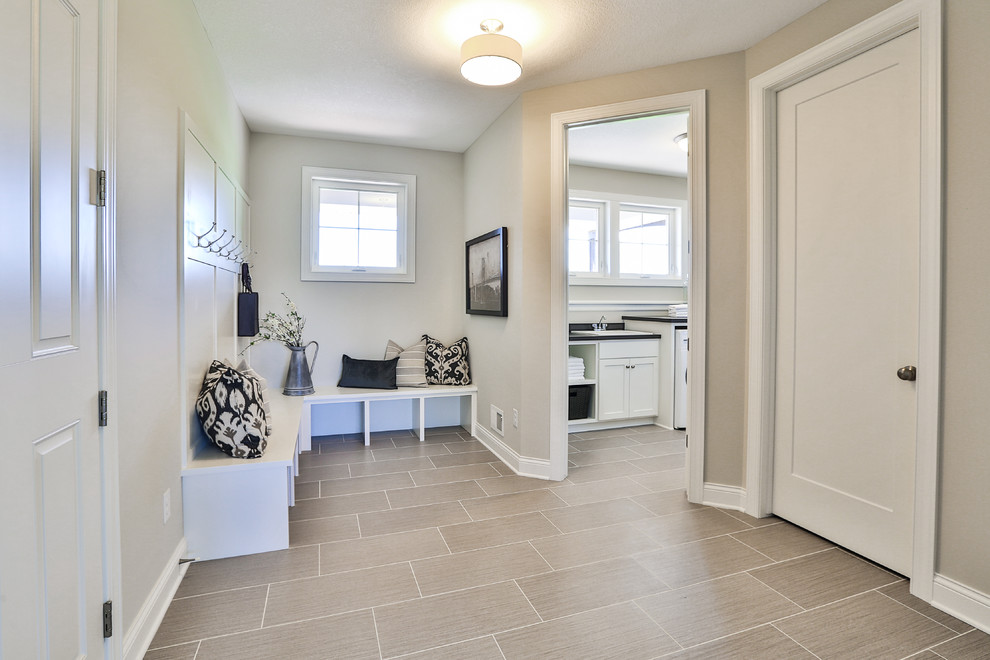 Inspiration for a large timeless ceramic tile utility room remodel in Minneapolis with a drop-in sink and a side-by-side washer/dryer