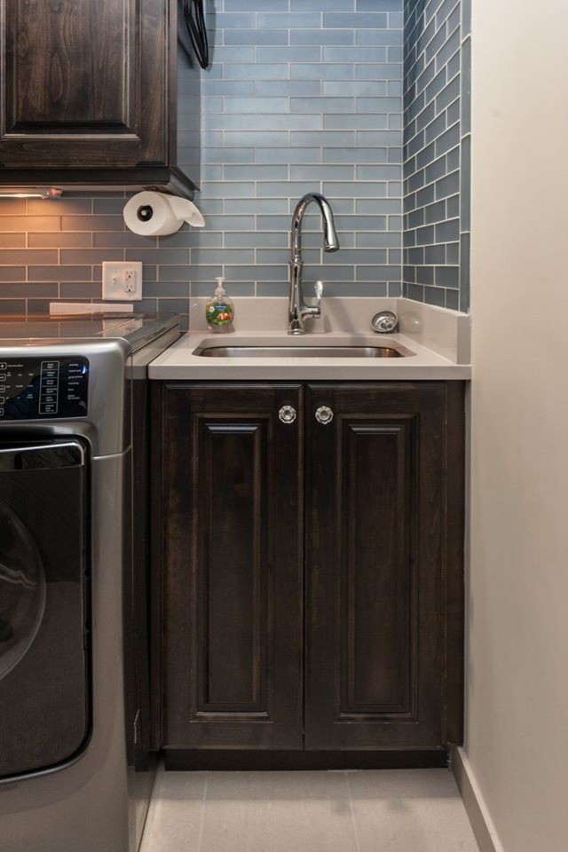 Inspiration for a transitional beige floor laundry room remodel in Salt Lake City with an undermount sink, shaker cabinets, dark wood cabinets, quartz countertops, white walls and a side-by-side washer/dryer