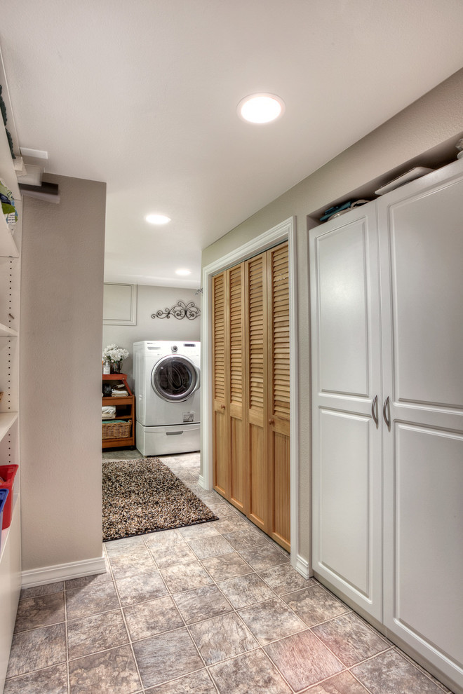 Elegant linoleum floor laundry room photo in Seattle with beige walls