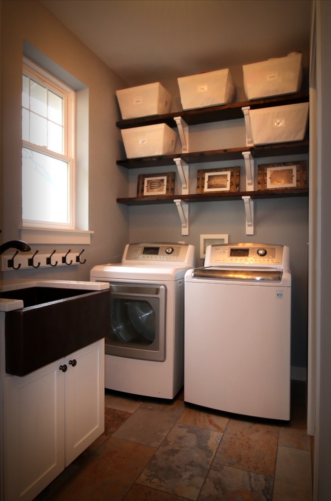 Laundry room - cottage ceramic tile laundry room idea in Chicago with a farmhouse sink, shaker cabinets, white cabinets, gray walls, quartz countertops and a side-by-side washer/dryer