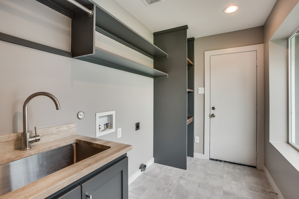 Inspiration for a mid-sized craftsman single-wall porcelain tile and gray floor dedicated laundry room remodel in Dallas with an undermount sink, shaker cabinets, gray cabinets, marble countertops, gray walls and a side-by-side washer/dryer
