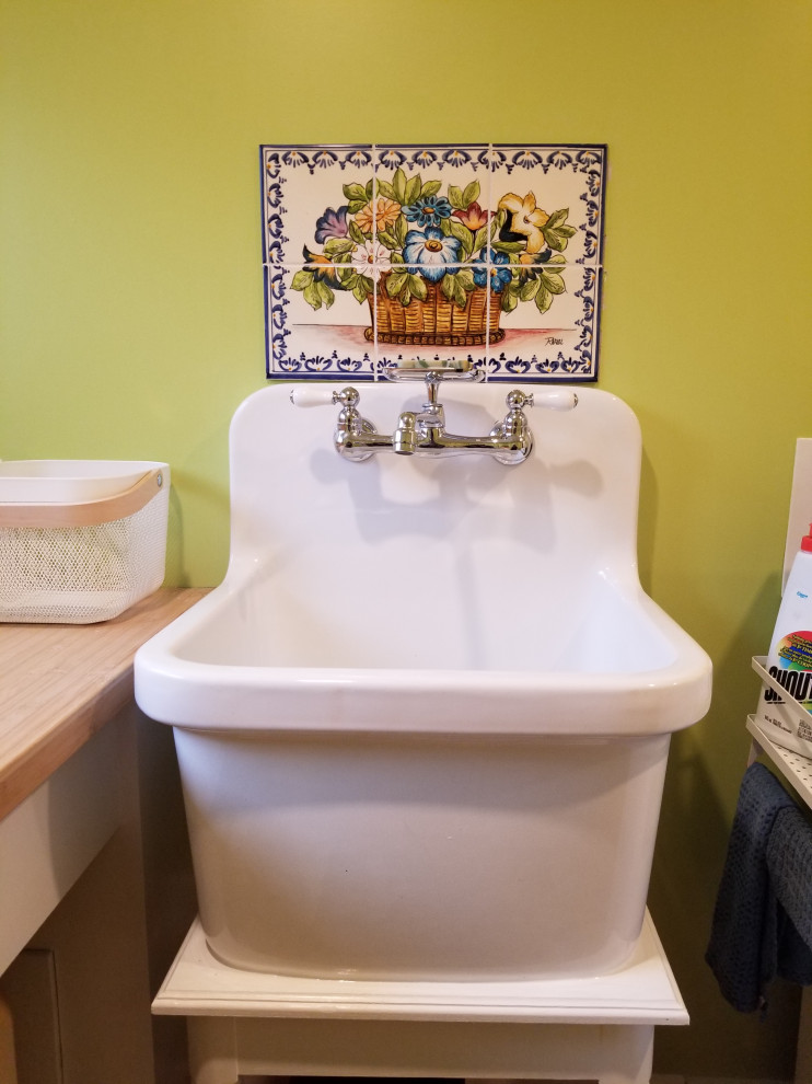 This is an example of a medium sized classic l-shaped separated utility room in Other with an utility sink, white cabinets, wood worktops, green walls, porcelain flooring, a side by side washer and dryer, brown floors, brown worktops and shaker cabinets.