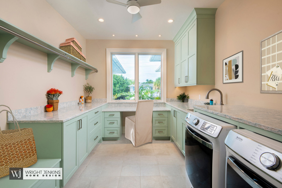 Inspiration for a large nautical u-shaped utility room in Tampa with a submerged sink, shaker cabinets, green cabinets, engineered stone countertops, beige walls, porcelain flooring, a side by side washer and dryer, beige floors and grey worktops.