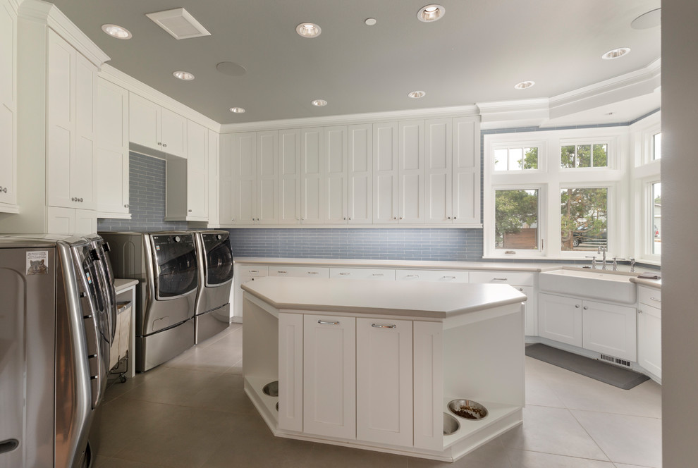 This is an example of an expansive traditional utility room in Portland with a belfast sink, shaker cabinets, white cabinets, laminate countertops, grey walls, porcelain flooring, a side by side washer and dryer and beige floors.