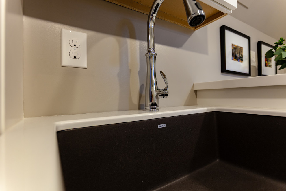 This is an example of a large classic single-wall separated utility room in Minneapolis with a submerged sink, beaded cabinets, white cabinets, marble worktops, beige walls, vinyl flooring, a side by side washer and dryer, beige floors and white worktops.