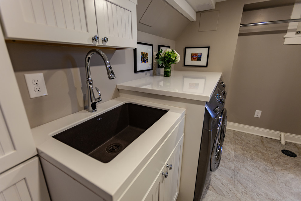 Inspiration for a large classic single-wall separated utility room in Minneapolis with a submerged sink, beaded cabinets, white cabinets, marble worktops, beige walls, vinyl flooring, a side by side washer and dryer, beige floors and white worktops.