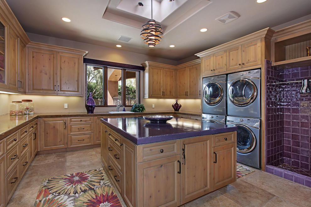 Example of an island style laundry room design in Orange County