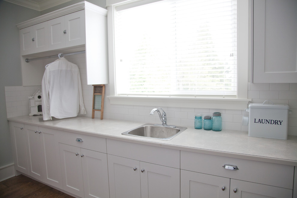 Large traditional l-shaped separated utility room in Vancouver with a single-bowl sink, shaker cabinets and white cabinets.
