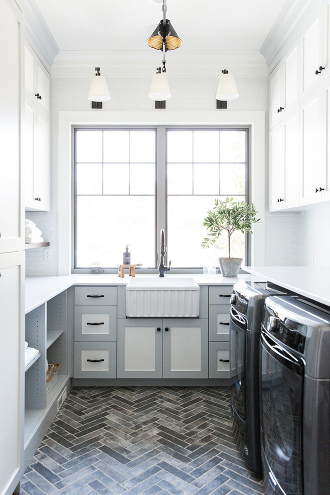 This is an example of a medium sized country u-shaped separated utility room in Salt Lake City with white walls, a side by side washer and dryer and white worktops.
