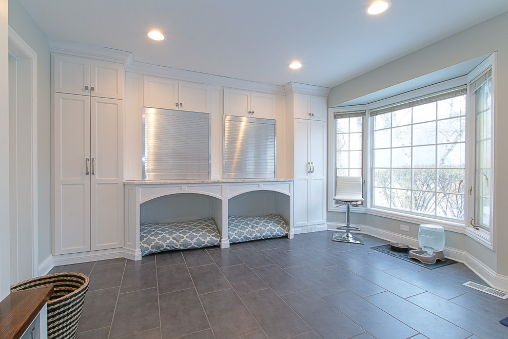 Photo of a large traditional utility room in Chicago with a submerged sink, white cabinets, grey walls and a side by side washer and dryer.